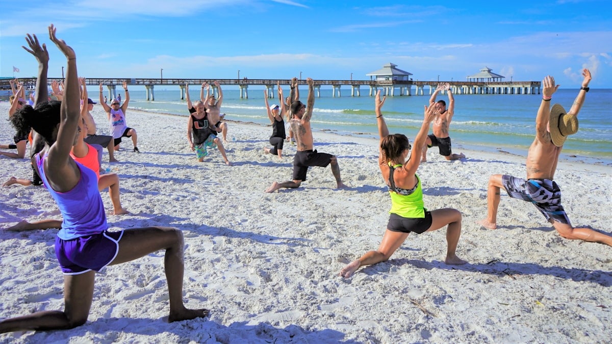 Yoga Workout On The Beach With Group